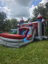 Titanium double-lane bounce house combo set up on grass